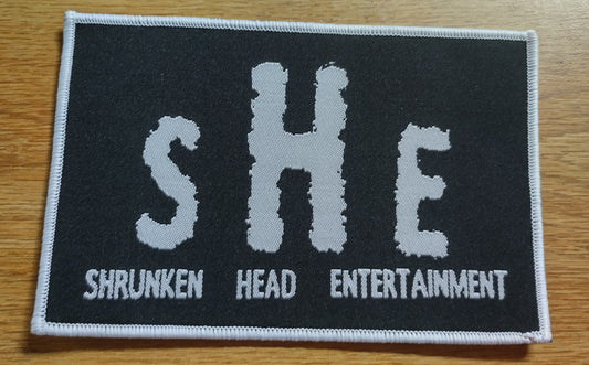 Shrunken Head Ent logo white border Woven Patch